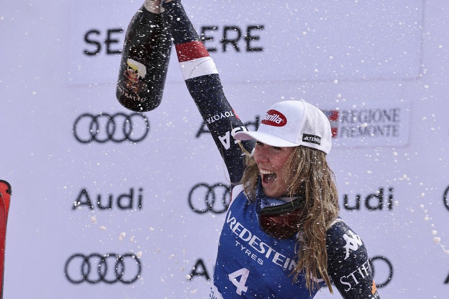 United States&#039; Mikaela Shiffrin celebrates her 100th victory after an alpine ski, women&#039;s World Cup slalom, in Sestriere, Italy, Sunday, Feb. 23, 2025. (AP Photo/Marco Trovati)
