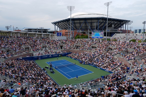 A crowd watches as Stan Wawrinka, of Switzerland, bottom, competes against Matteo Berrettini, of Italy, during the first round of the U.S. Open tennis championships Monday, Aug. 31, 2026, in New York. ...