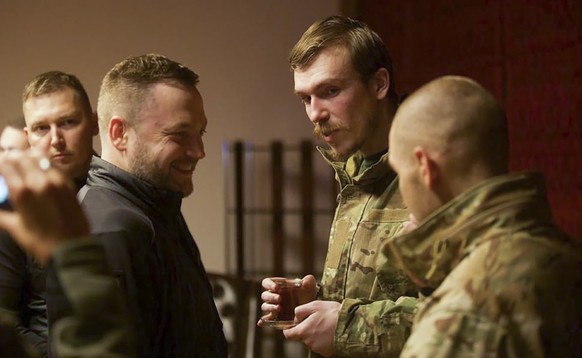 In this photo provided by the Ukrainian Interior Ministry Press Office, Ukrainian Interior Minister Denys Monastyrsky, second left, talks with Azov regiment commander Denys Prokopenko, second right, w ...