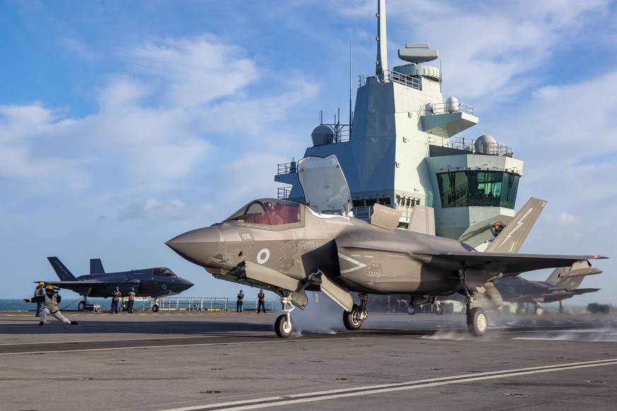 epa09631120 F-35B takes off from HMS Queen Elizabeth for the final time, 08 December 2021 (issued 09 December 2021). The Merlin Mk2 aircraft took off first shortly followed by the F-35B Lightening Jet ...