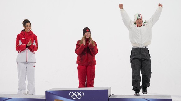 Bronze medalist Italy's Flora Tabanelli, right, celebrates on the podium alongside silver medalist China's Eileen Gu, left, and gold medalist Canada's Megan Oldham after the women' ...