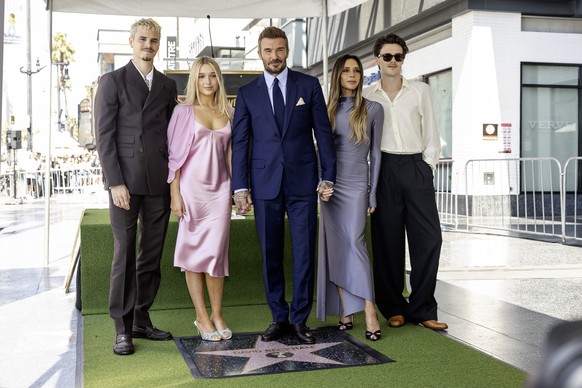 epa13033536 British former soccer player David Beckham (C) poses with his family during a ceremony honoring him with a star on the Hollywood Walk of Fame in Los Angeles, California, USA, 12 June 2026. ...
