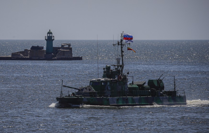 epa10009880 A picture taken during a visit to Mariupol organized by the Russian military shows a Russian navy ship on guard in the cargo sea port of Mariupol, Ukraine, 12 June 2022. Russian Defense Mi ...