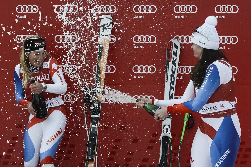 Lara Gut of Switzerland, left, the winner and Nadja Kamer of Switzerland, right, 3rd place, celebrates with champagne on the podium during the Women&amp;#039;s Downhill race at the FIS Alpine Ski Worl ...