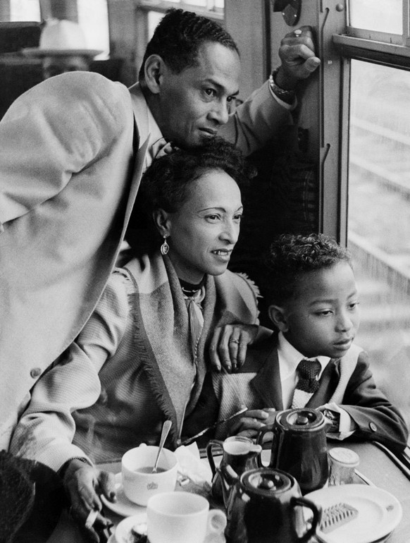 Empire Windrush - to Victoria Station by Train: Caribbean Family. June 22, 1948