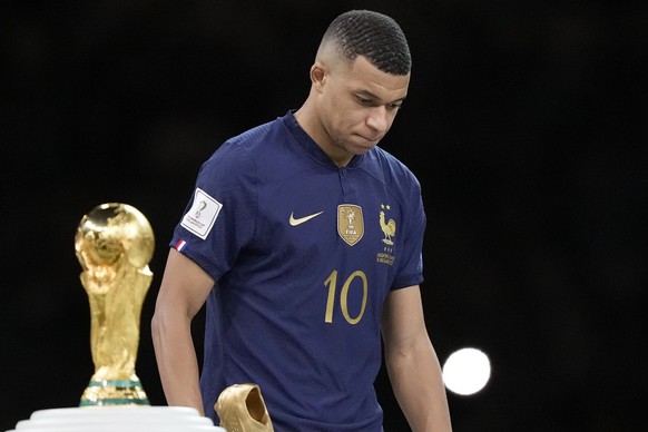 France&#039;s Kylian Mbappe walks past the trophy at the end of the World Cup final soccer match between Argentina and France at the Lusail Stadium in Lusail, Qatar, Sunday, Dec. 18, 2022. Argentina w ...