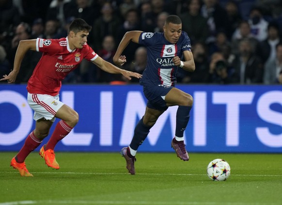 PSG&#039;s Kylian Mbappe, right, duels for the ball with Benfica&#039;s Alexander Bah during the Champions League Group H soccer match between Paris Saint Germain and Benfica, at the Parc des Princes  ...