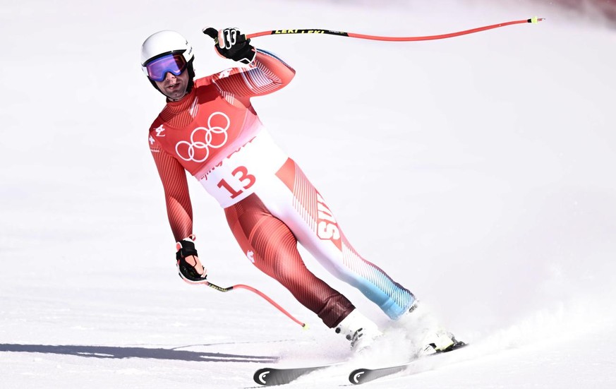epa09734441 Beat Feuz of Switzerland celebrates after his run in the Men&#039;s Downhill race of the Alpine Skiing events of the Beijing 2022 Olympic Games at the Yanqing National Alpine Ski Centre Sk ...