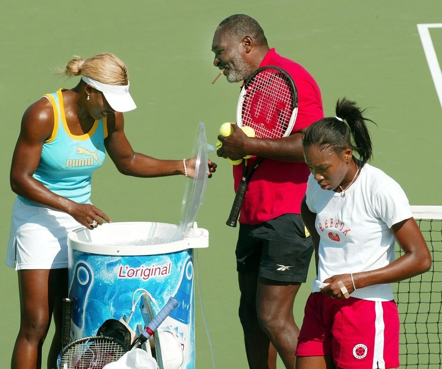 TAC02 - 20020905 - NEW YORK, NY, UNITED STATES : Number one seed Serena Williams (L) and her sister number two seed Venus Williams (R) take a break from a morning practice sesssion with their father R ...