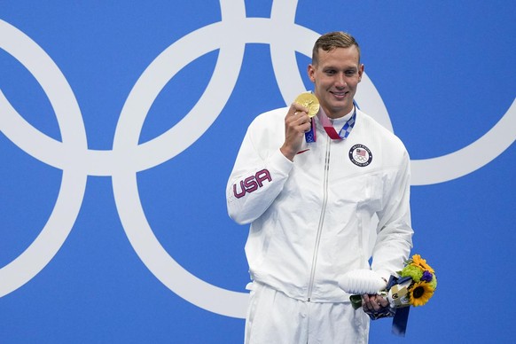 Caeleb Dressel, of the United States, poses with the gold medal after winning the men&#039;s 100-meter freestyle final at the 2020 Summer Olympics, Thursday, July 29, 2021, in Tokyo, Japan. (AP Photo/ ...