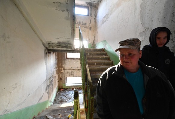 Lyubov Tyasova, the 50-year-old tour guide, and her son Vadim, 13, walk inside an abandoned Soviet-era building in the small town of Orlovka, some 90 kms from Bishkek, on March 11, 2025. Like millions ...