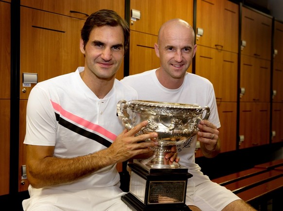 epa06481360 A handout photo made available by Tennis Australia shows Roger Federer of Switzerland posing with his trophy and his coach Ivan Ljubicic (R) in the men&#039;s locker room after winning the ...