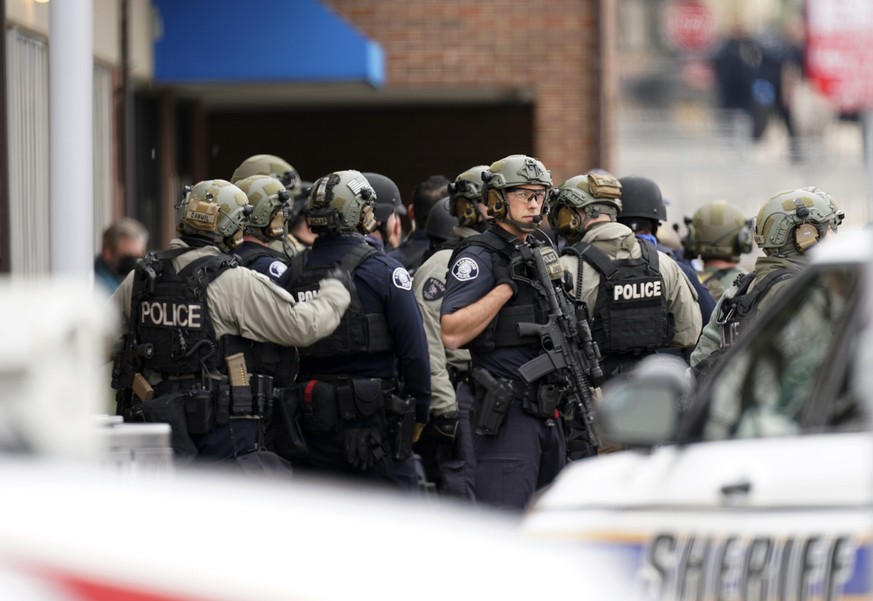 Police stand outside a King Soopers grocery store where authorities say multiple people have been killed in a shooting, Monday, March 22, 2021, in Boulder, Colo. (AP Photo/David Zalubowski)