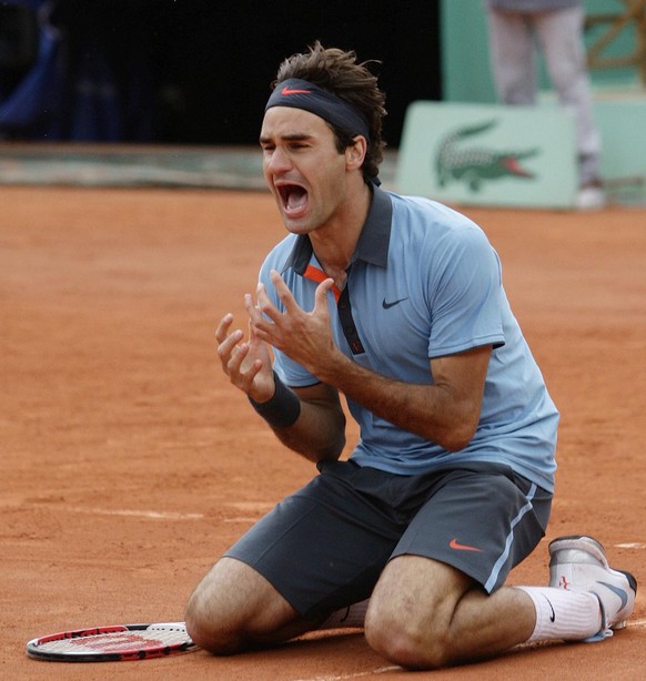 Switzerland's Roger Federer jubilates after defeating Sweden's Robin Soderling during their men's singles final match of the French Open tennis tournament at the Roland Garros stadium i ...