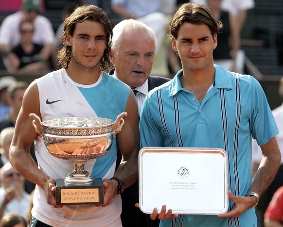 Spain&#039;s Rafael Nadal, left, and Switzerland&#039;s Roger Federer pose with their trophies after the final match of the French Open tennis tournament, at the Roland Garros stadium, in Paris, Sunda ...