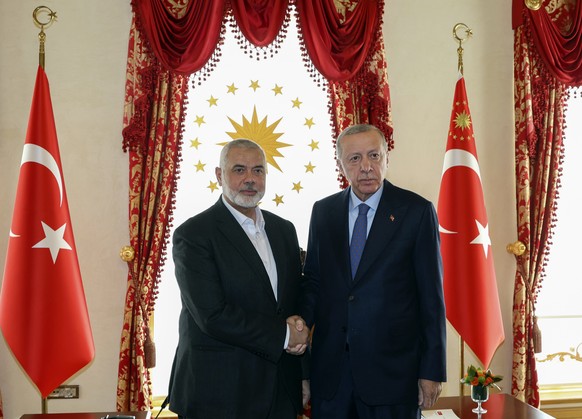In this photo released by the Turkish Presidency, Turkey&#039;s President Recep Tayyip Erdogan, right, and Hamas leader Ismail Haniyeh, shake hands during their meeting in Istanbul, Turkey, Saturday,  ...