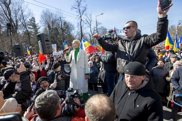 epa10517389 Marina Tauber (C-L), deputy of the political party Shor, speaks to supporters during a protest in the main street of Chisinau, Moldova, 12 March 2023. The protesters called on the governme ...