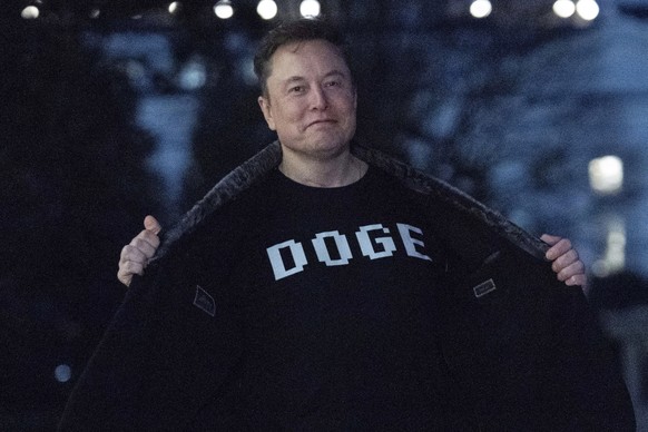 FILE - Elon Musk flashes his T-shirt that reads "DOGE" to the media as he walks on the South Lawn of the White House, in Washington, March 9, 2025. (AP Photo/Jose Luis Magana, File)
Elon Mus ...
