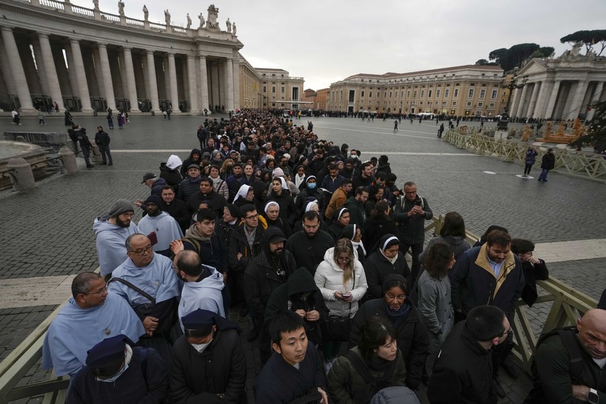 People wait in a line to enter Saint Peter's Basilica at the Vatican where late Pope Benedict 16 is being laid in state at The Vatican, Monday, Jan. 2, 2023. Benedict XVI, the German theologian w ...