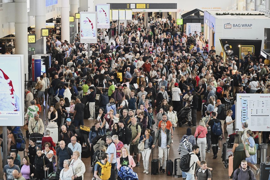 People walk by a departures board after a cyber attack caused delays at Brussels International Airport in Zaventem, Belgium, Saturday, Sept. 20, 2025. (AP Photo/Harry Nakos)
EU Europe Airports Cyberat ...