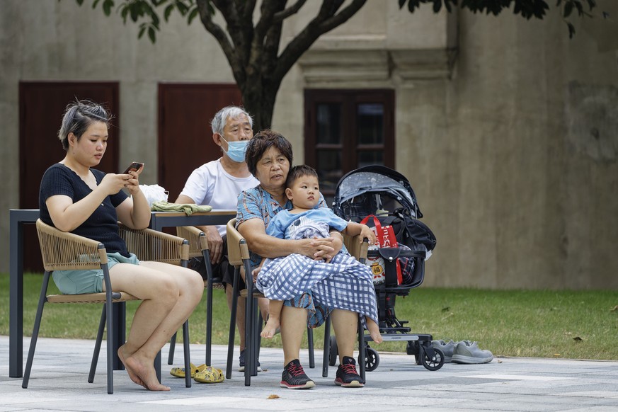 epa10102545 People sit in a public square in Shanghai, China, 02 August 2022. China&#039;s total fertility rate has dropped below 1.3 percent in recent years. The growth rate has slowed down, and the  ...