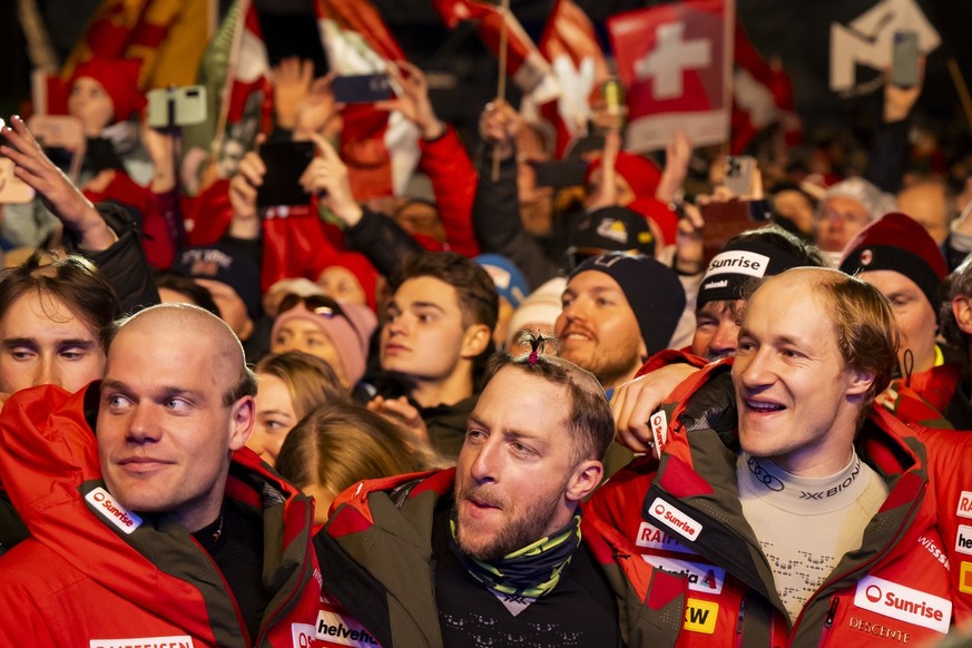 Stefan Rogentin, Justin Murisier and Marco Odermatt of Switzerland celebrate during the medals ceremony of the men&#039;s Downhill race at the 2025 FIS Alpine World Ski Championships, in Saalbach-Hint ...