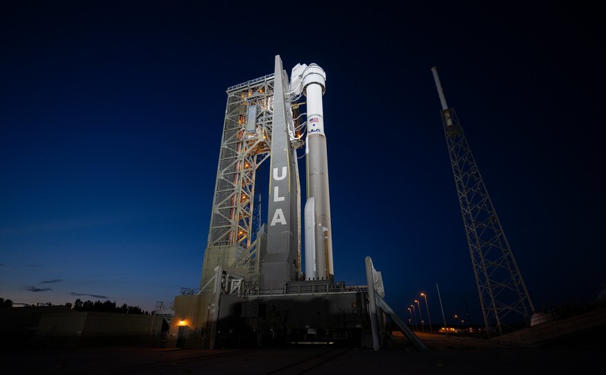 epa11320845 A handout photo made available by NASA shows a United Launch Alliance Atlas V rocket with Boeing&#039;s CST-100 Starliner spacecraft aboard on the launch pad illuminated by spotlights ahea ...