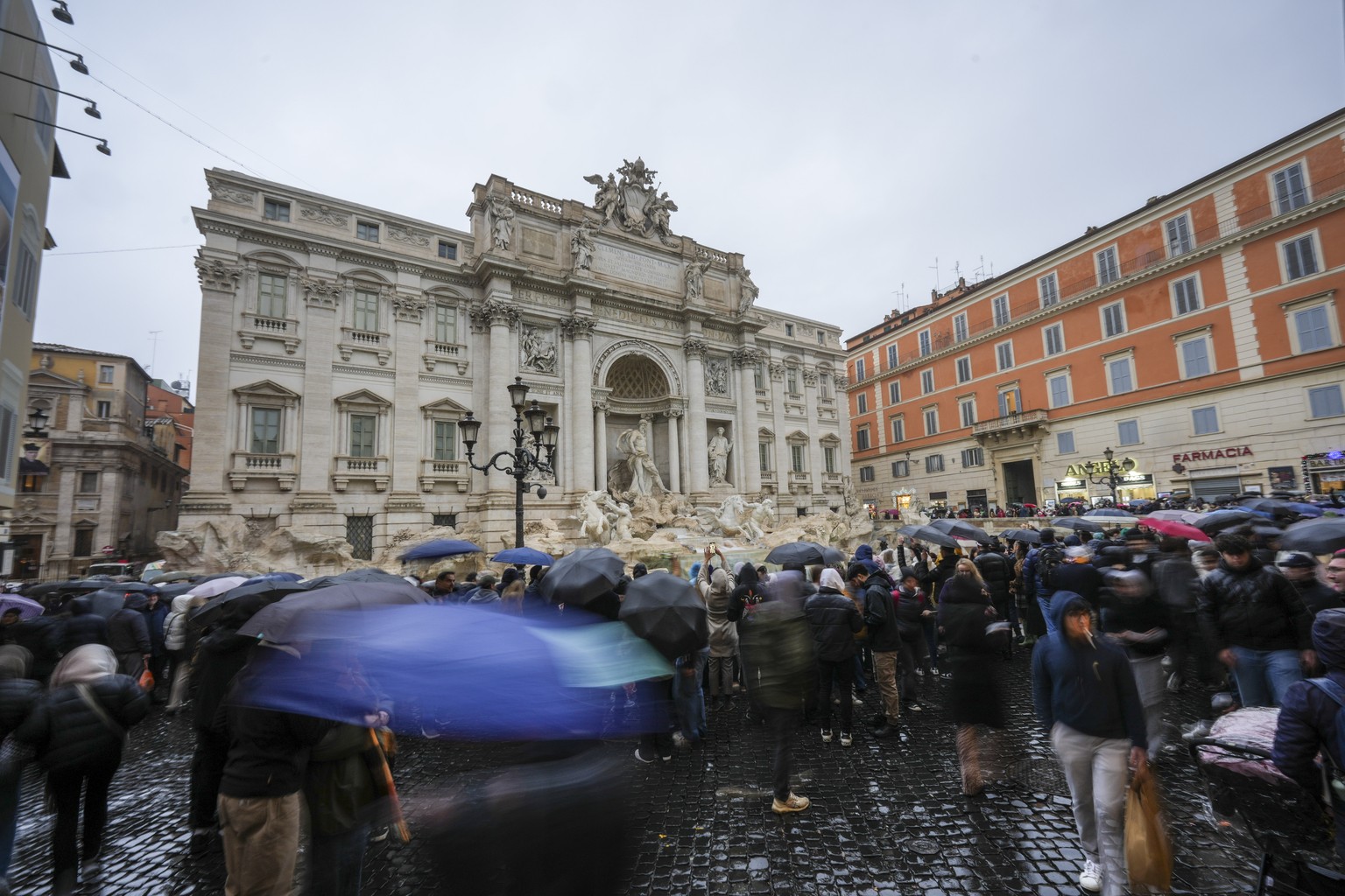 People admire the 18th century Trevi Fountain, one of Rome&#039;s most iconic landmarks, as it reopens to the public after undergoing maintenance, just on time for the start of the Jubilee Year, an ev ...