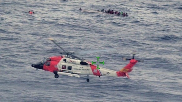 epa09943655 A handout photo made available by US Customs and Border Protection shows US Coast Guard air and surfaces rescue crews, Customs and Border Protection law enforcement boat crews and partner  ...