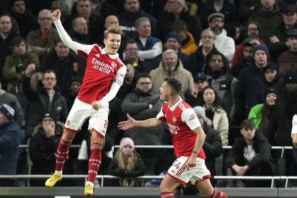 Arsenal&#039;s Martin Odegaard, left, celebrates with Arsenal&#039;s Granit Xhaka after scoring his side&#039;s second goal during the English Premier League soccer match between Tottenham Hotspur and ...