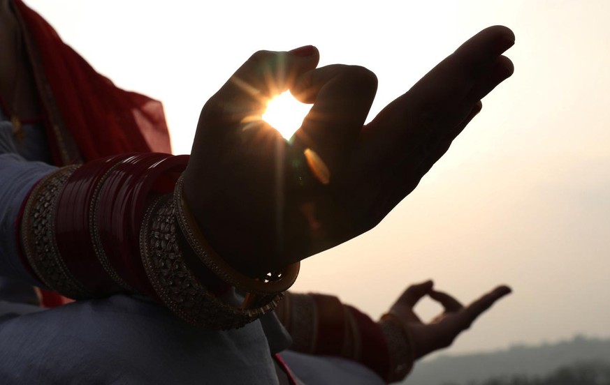 epa08498449 An Indian woman practices yoga on the eve of World Yoga Day at the village of Jalot, India, 20 June 2020. World Yoga Day is observed annually on 21 June and was themed &#039;Yoga for Healt ...