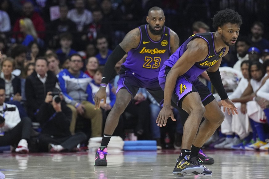 PHILADELPHIA, PENNSYLVANIA - JANUARY 28: Bronny James #9 and LeBron James #23 of the Los Angeles Lakers in action against the Philadelphia 76ers at the Wells Fargo Center on January 28, 2025 in Philad ...
