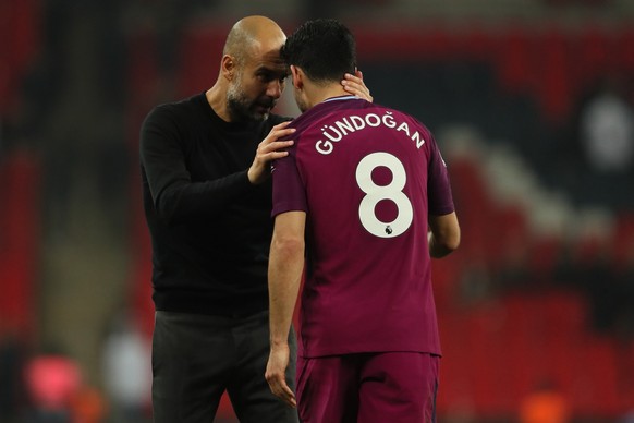 LONDON, ENGLAND - APRIL 14: Manchester City manager Pep Guardiola and Ilkay Gundogan of Manchester City during the Premier League match between Tottenham Hotspur and Manchester City at Wembley Stadium ...