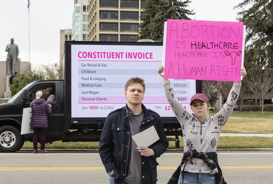 FILE - Blake Coker and Autumn Myers protest Senate Bill 1309, the Fetal Heartbeat Protection Act, during a rally at the Idaho Capitol on Saturday, March, 19, 2022 in Boise, Idaho. Idaho on Wednesday,  ...