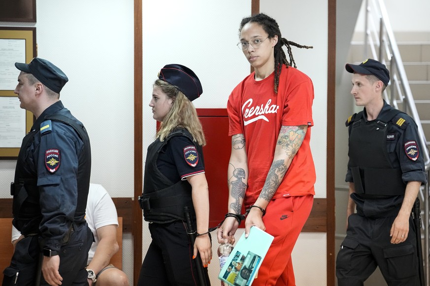 WNBA star and two-time Olympic gold medalist Brittney Griner is escorted to a courtroom for a hearing, in Khimki outside Moscow, Russia, Thursday, July 7, 2022. Griner on Thursday pleaded guilty to dr ...