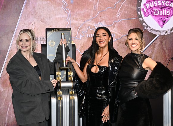 Kimberly Wyatt, from left, Nicole Scherzinger and Ashley Roberts of the Pussycat Dolls participate in the ceremonial lighting of the Empire State Building in celebration of their global reunion " ...