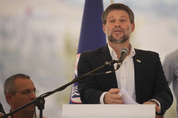 CORRECTS DAY Israeli Finance Minister Bezalel Smotrich speaks to journalists during a press conference about new settlement construction in the Israel-occupied West Bank near Maale Adumim, Thursday, A ...