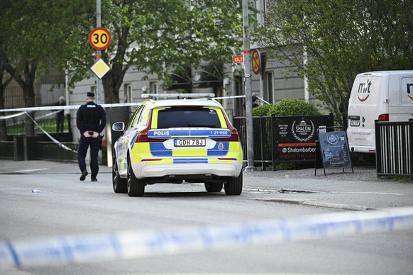 epa12063111 Police at the scene after a suspected shooting at Vaksala Square in Uppsala, Sweden, 29 April 2025. According to police, several people were found with injuries that indicate gunshot wound ...