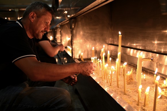 People light candles for former Bosnian Serb wartime general Ratko Mladic, in front of church in the Bosnian town of Banja Luka, 240 kms. (140 miles) northwest of Sarajevo, Thursday, August. 27, 2026. ...