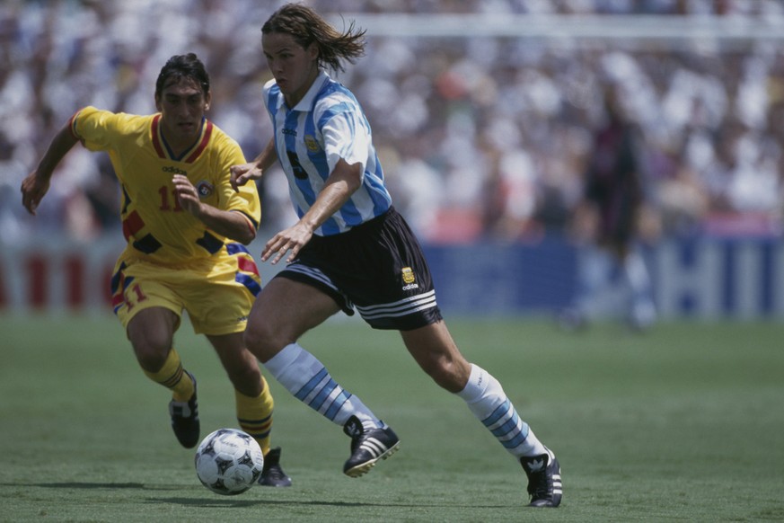 (L-R): Ilie Dumitrescu (Romania) and Fernando Redondo (Argentina) during a round of 16 match of the 1994 FIFA World Cup. (Photo by Christian Liewig/TempSport/Corbis via Getty Images)