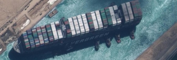 epa09105214 A handout satellite image made available by MAXAR Technologies shows , the Ever Given container ship after it has been moved away from the eastern bank of the canal and tugboats trying to  ...