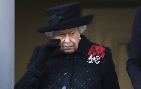 FILE - Britain&#039;s Queen Elizabeth II wipes her cheek as she watches the Remembrance Sunday ceremony at the Cenotaph in Whitehall in London, Sunday, Nov. 10, 2019. Buckingham Palace says Queen Eliz ...