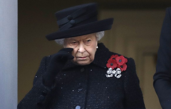 FILE - Britain's Queen Elizabeth II wipes her cheek as she watches the Remembrance Sunday ceremony at the Cenotaph in Whitehall in London, Sunday, Nov. 10, 2019. Buckingham Palace says Queen Eliz ...