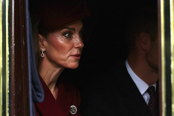 Britain&#039;s Catherine, Princess of Wales, and Britain&#039;s Prince William, Prince of Wales, travel in the Semi-State Landau during a horse-drawn procession towards Windsor Castle, at the start of ...