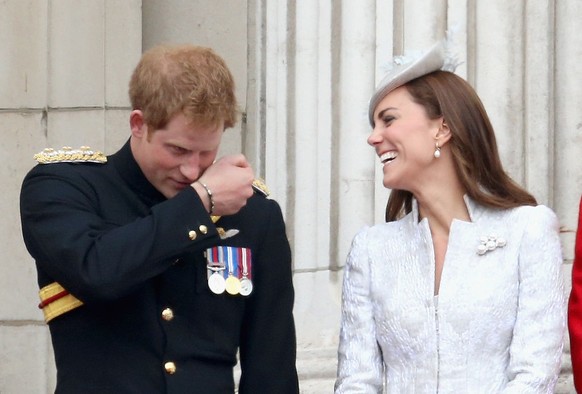 LONDON, ENGLAND - JUNE 14: Prince Harry pretends to talk into a microphone as he jokes with Catherine, Duchess of Cambridge during Trooping the Colour - Queen Elizabeth II&#039;s Birthday Parade, at T ...