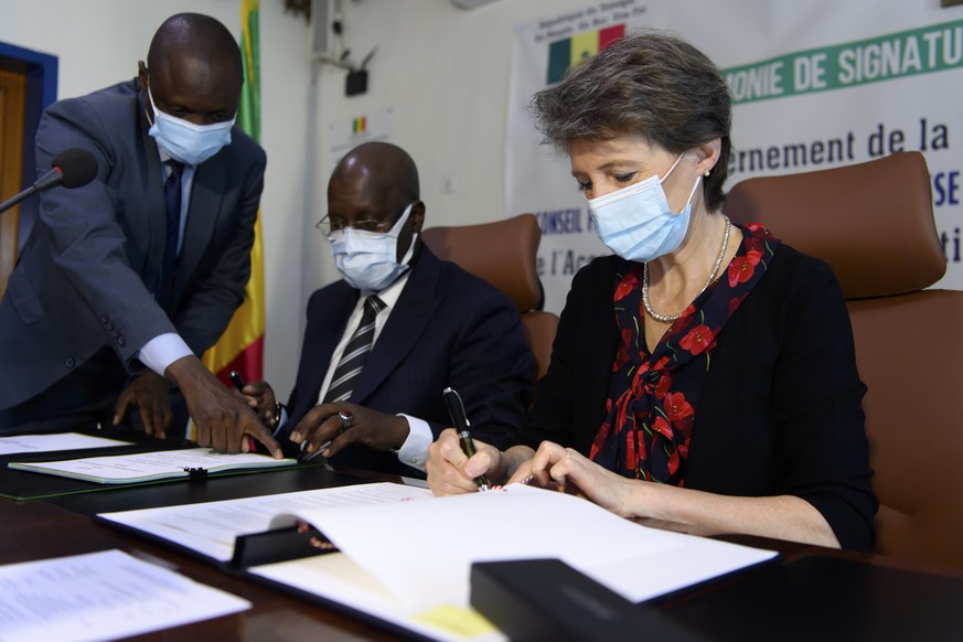 epa09325234 Swiss Federal Councillor Simonetta Sommaruga (R) and Abdou Karim Sall, Senegalese Minister for Environment and Sustainable Development sign a bilateral climate protection agreement under A ...