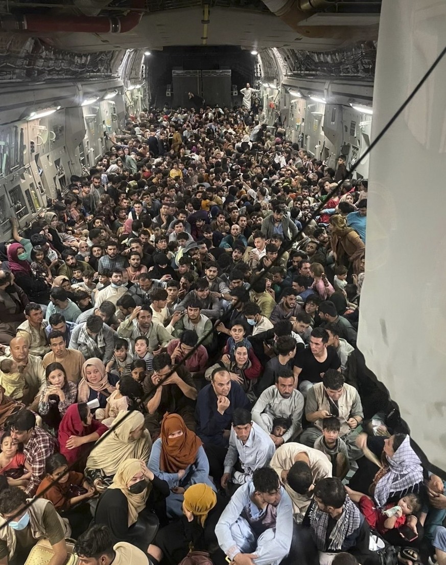 epa09417900 A picture made available on 17 August 2021 shows approximately 640 Afghan citizens being evacuated on an United States Air Force C-17 Globemaster III airplane from Hamid Karzai Internation ...