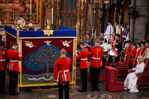 LONDON, ENGLAND - MAY 06: Queen Camilla (right) watches as King Charles III is behind an anointing screen during their coronation ceremony in Westminster Abbey on May 6, 2023 in London, England. The C ...