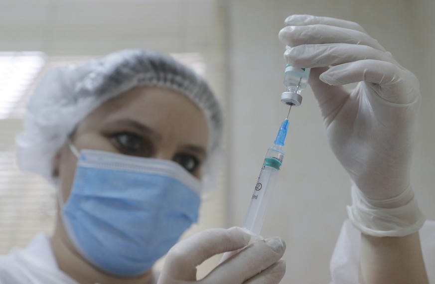 epa09112014 An Ukrainian medical worker prepares a doze of AstraZeneca (Covishield) vaccine for an injection in Kiev, Ukraine, 02 April 2021. Ukrainian Deputy Health Minister and Chief Medical Officer ...