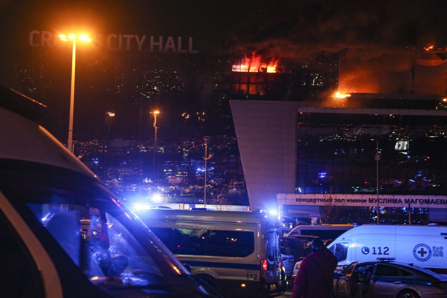 epa11237567 Fire rises above the burning Crocus City Hall concert venue following a shooting in Krasnogorsk, outside Moscow, Russia, 22 March 2024. A group of up to five gunmen has attacked the Crocus ...